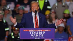 Donald Trump speaking at a rally in Mosinee, Wisconsin, addressing supporters and criticizing Kamala Harris and the 25th Amendment.